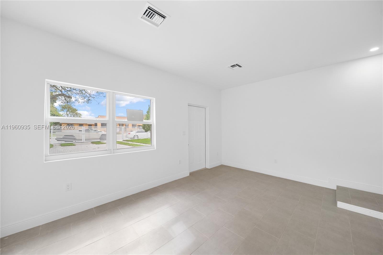 529 Northwest 56th Street Miami, FL 33127 - Photo 19 of 66 a view of an empty room with a window