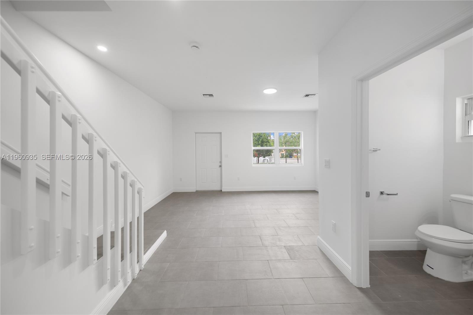 529 Northwest 56th Street Miami, FL 33127 - Photo 20 of 66 a view of a hallway with a white walls and a window