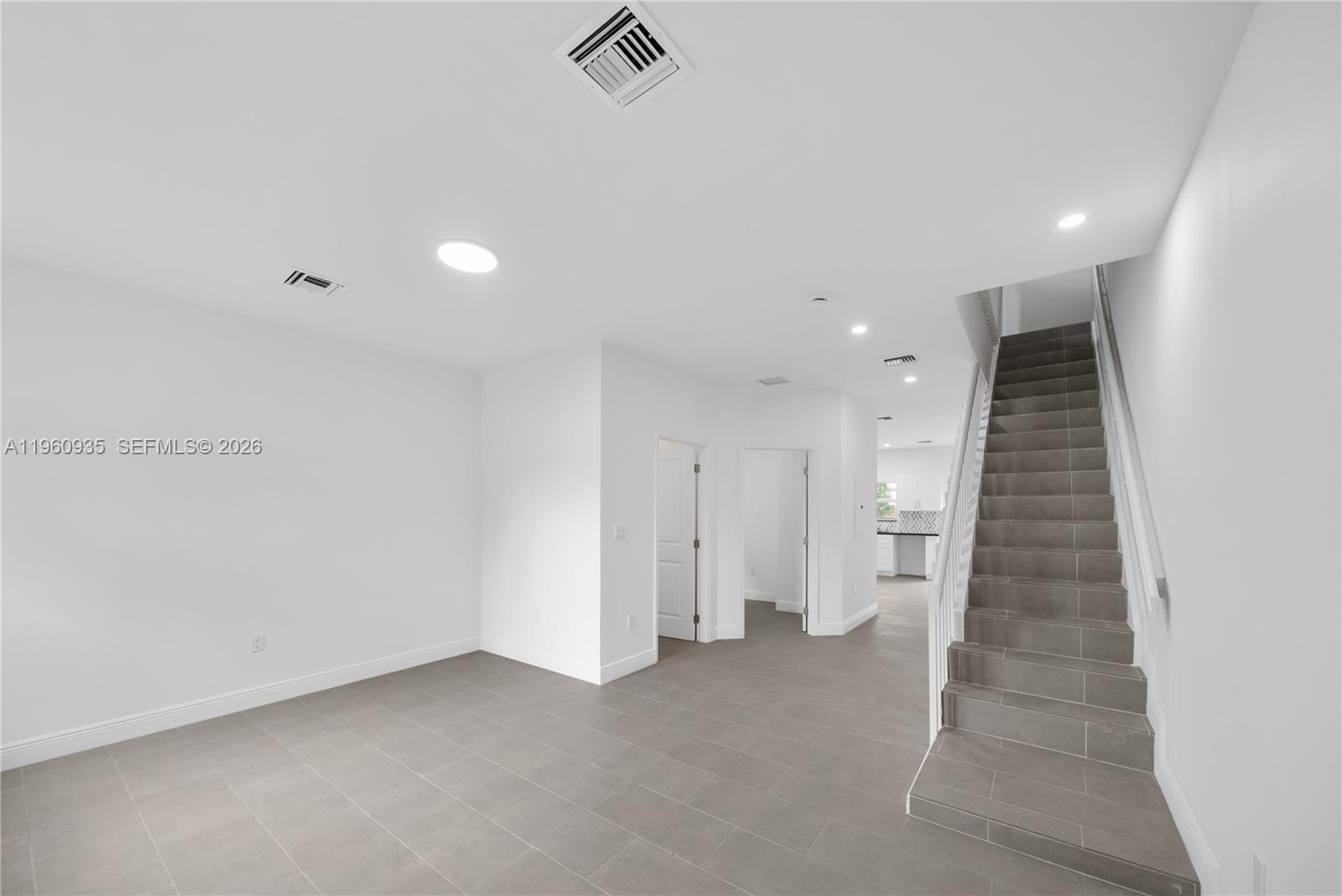 529 Northwest 56th Street Miami, FL 33127 - Photo 25 of 66 an empty room with a hallway and stairs