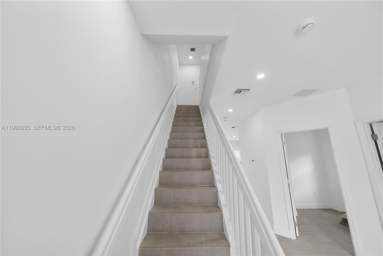 529 Northwest 56th Street Miami, FL 33127 - Photo 26 of 66 a view of a hallway with wooden floor and staircase
