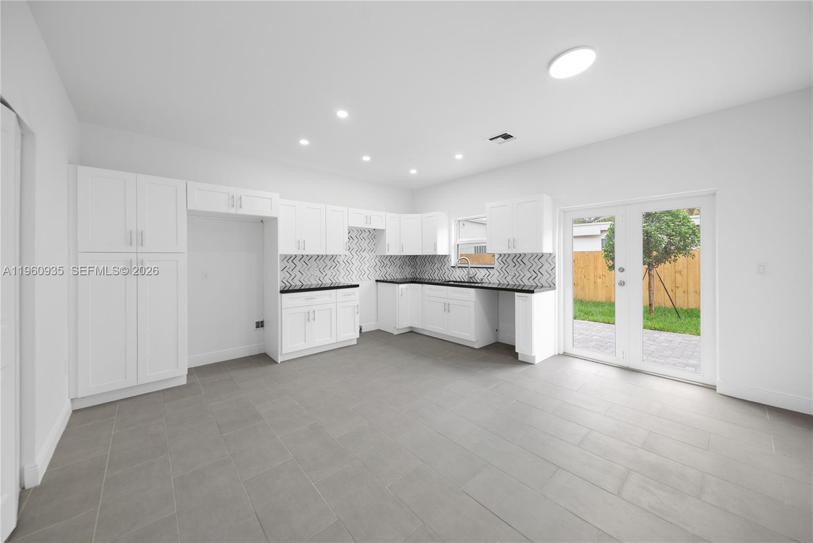 529 Northwest 56th Street Miami, FL 33127 - Photo 31 of 66 a view of a kitchen with a sink and white cabinets