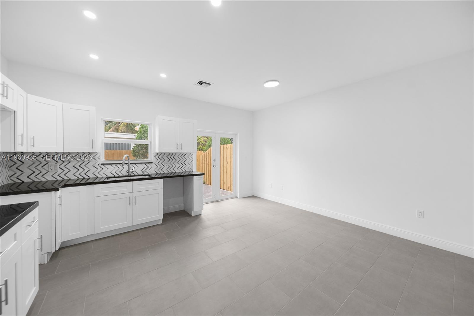 529 Northwest 56th Street Miami, FL 33127 - Photo 33 of 66 a large kitchen with granite countertop white cabinets and a granite counter tops