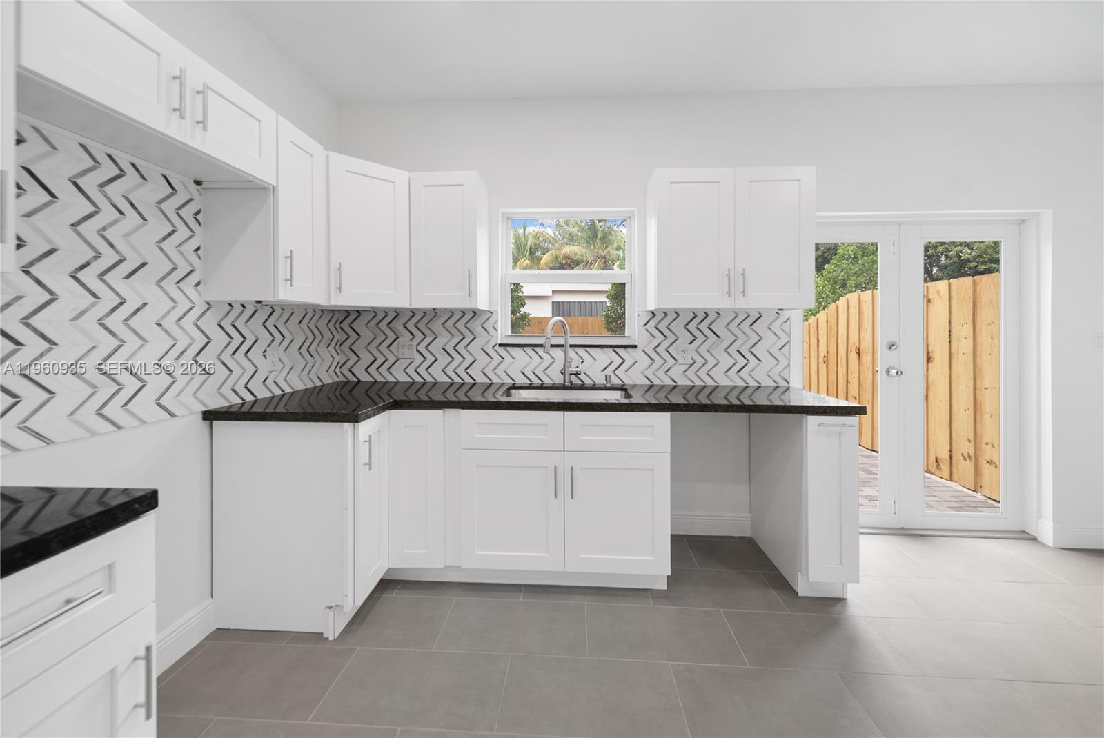 529 Northwest 56th Street Miami, FL 33127 - Photo 35 of 66 a kitchen with granite countertop white cabinets and a granite counter tops