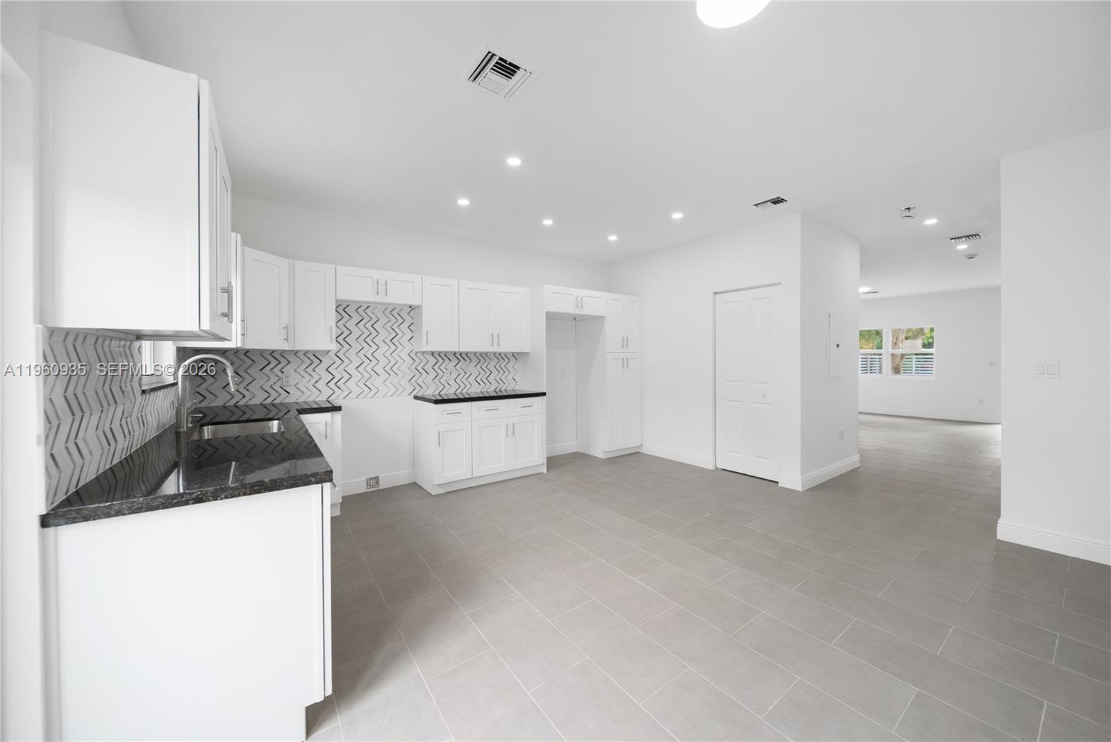 529 Northwest 56th Street Miami, FL 33127 - Photo 38 of 66 a kitchen with white cabinets and refrigerator