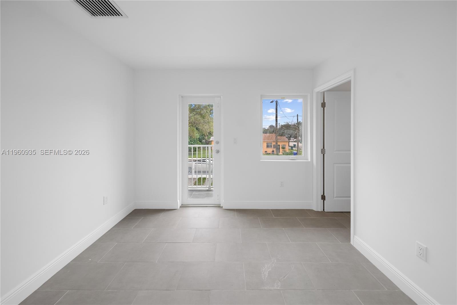 529 Northwest 56th Street Miami, FL 33127 - Photo 41 of 66 an empty room with windows