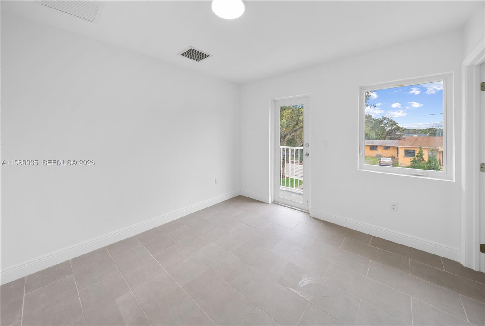 529 Northwest 56th Street Miami, FL 33127 - Photo 42 of 66 an empty room with a window