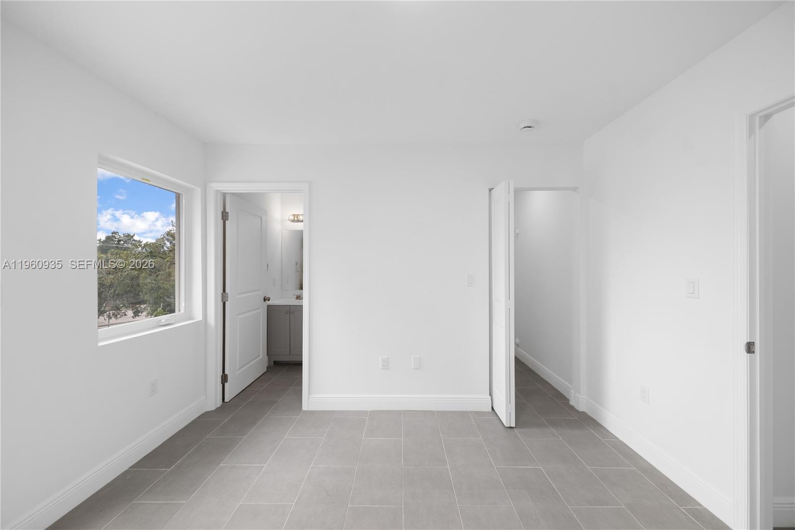 529 Northwest 56th Street Miami, FL 33127 - Photo 47 of 66 an empty room with windows and closet