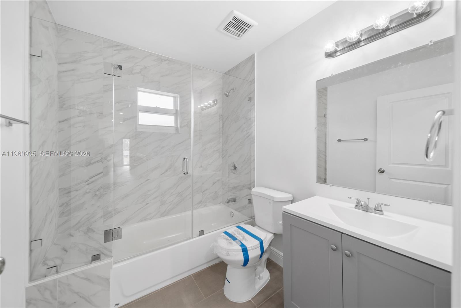 529 Northwest 56th Street Miami, FL 33127 - Photo 48 of 66 a bathroom with a sink mirror toilet and bathtub