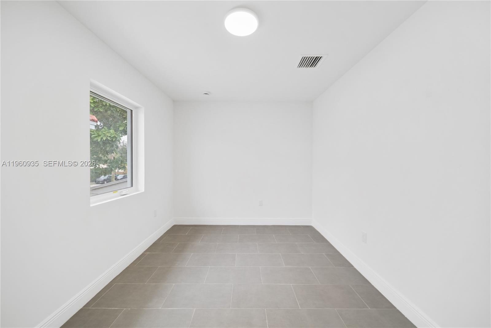 529 Northwest 56th Street Miami, FL 33127 - Photo 50 of 66 an empty room with a window