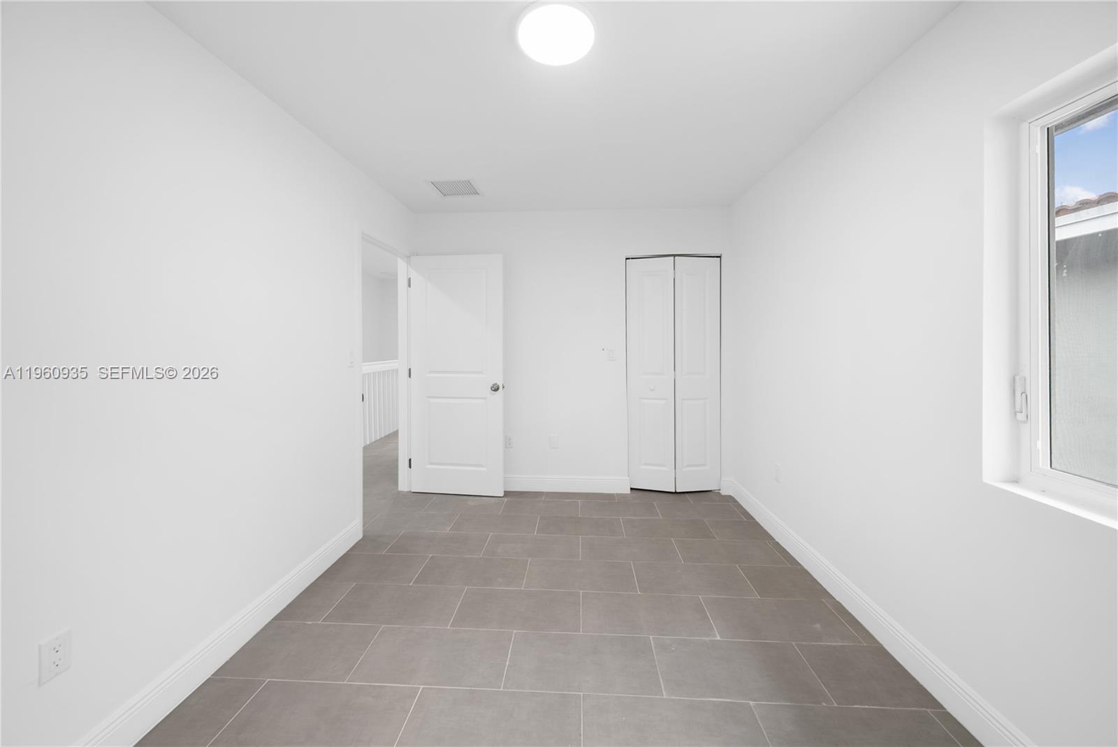 529 Northwest 56th Street Miami, FL 33127 - Photo 52 of 66 a view of an empty room with windows
