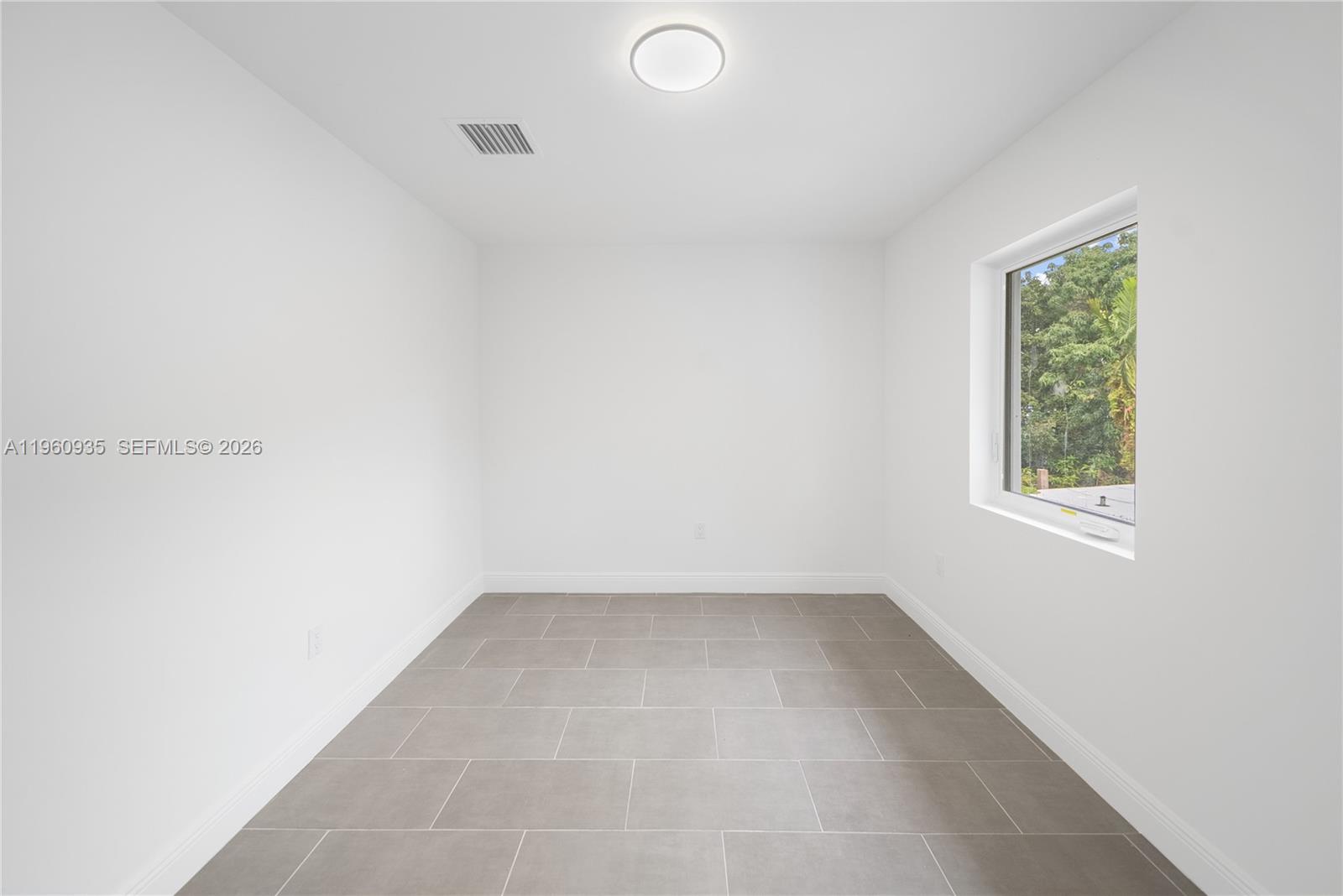 529 Northwest 56th Street Miami, FL 33127 - Photo 56 of 66 an empty room with a window