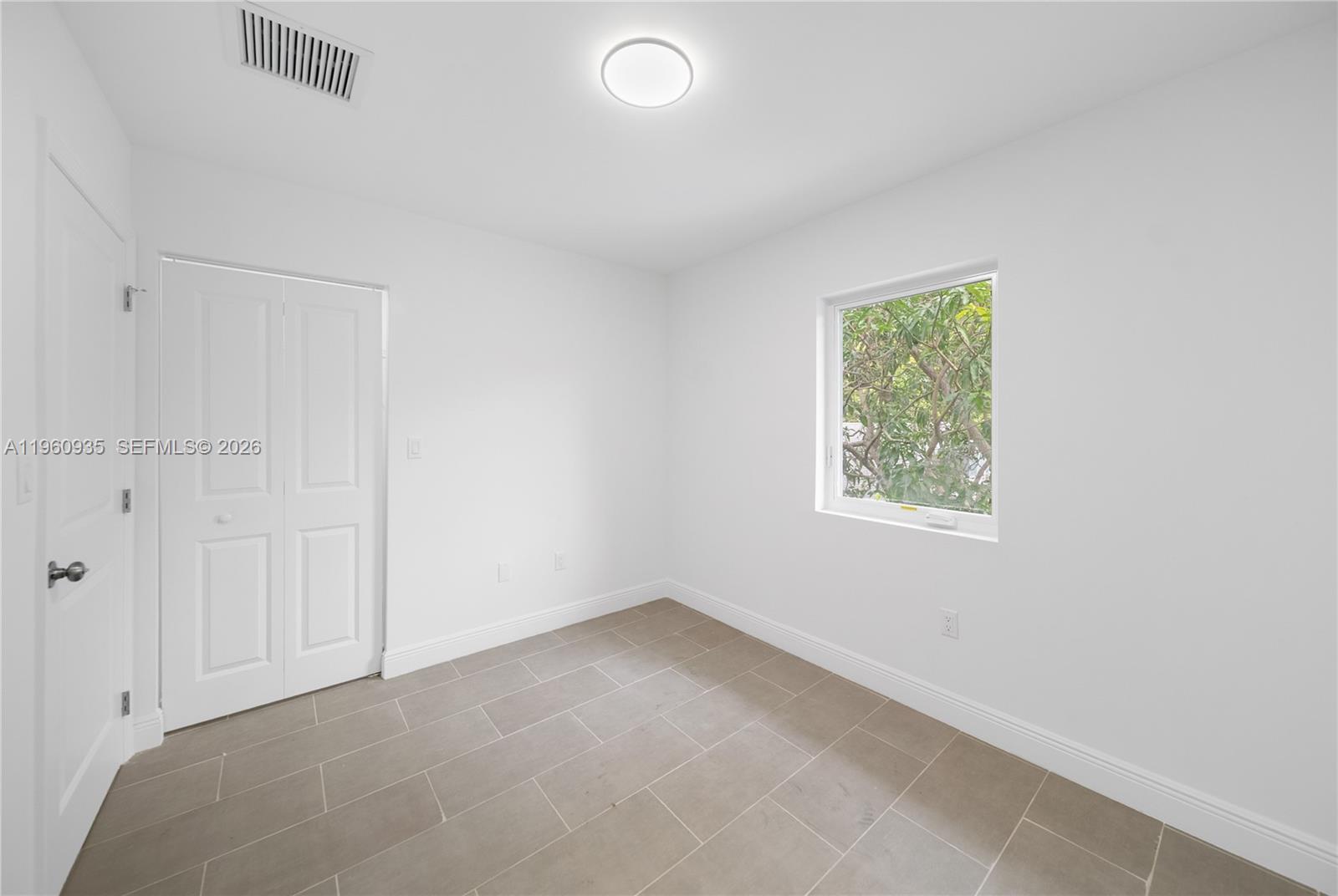 529 Northwest 56th Street Miami, FL 33127 - Photo 60 of 66 an empty room with a window