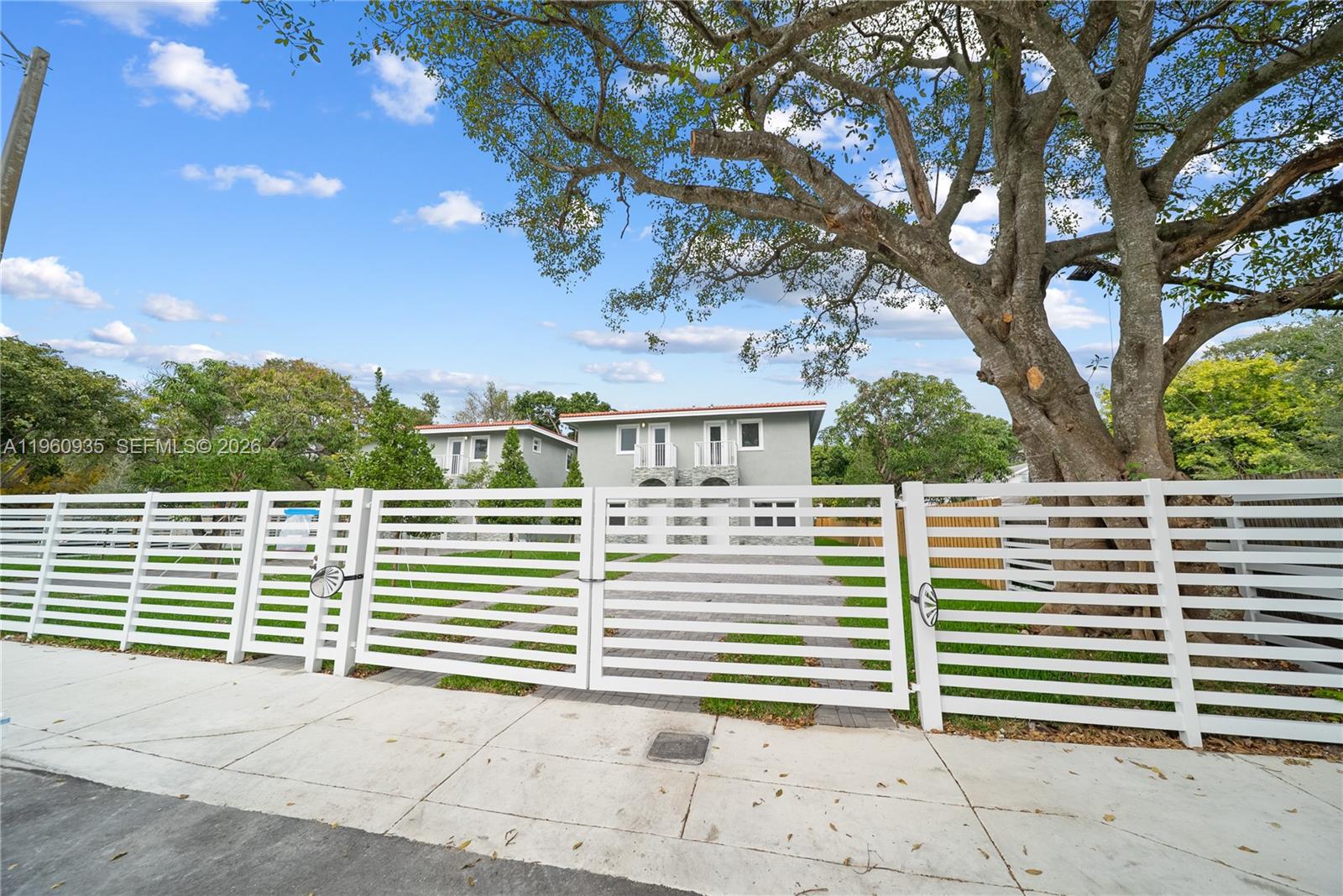 529 Northwest 56th Street Miami, FL 33127 - Photo 6 of 66 a view of a house with a tree in the background