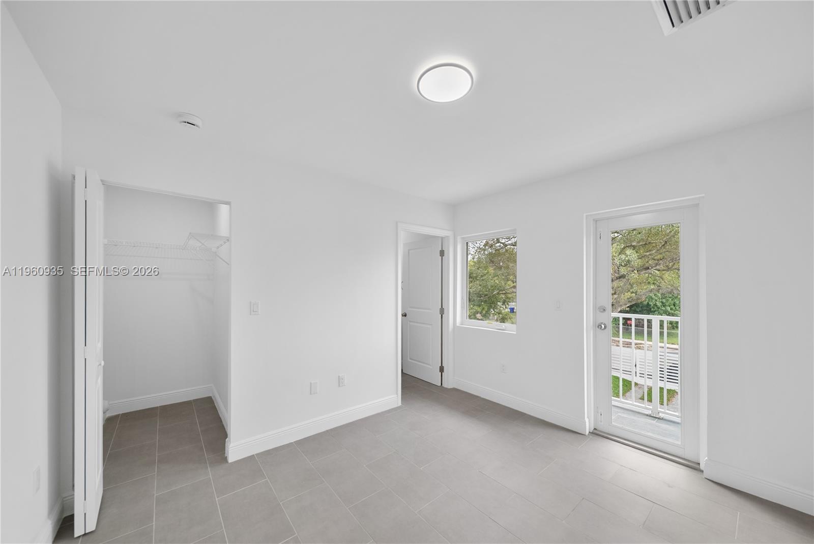 529 Northwest 56th Street Miami, FL 33127 - Photo 63 of 66 an empty room with windows