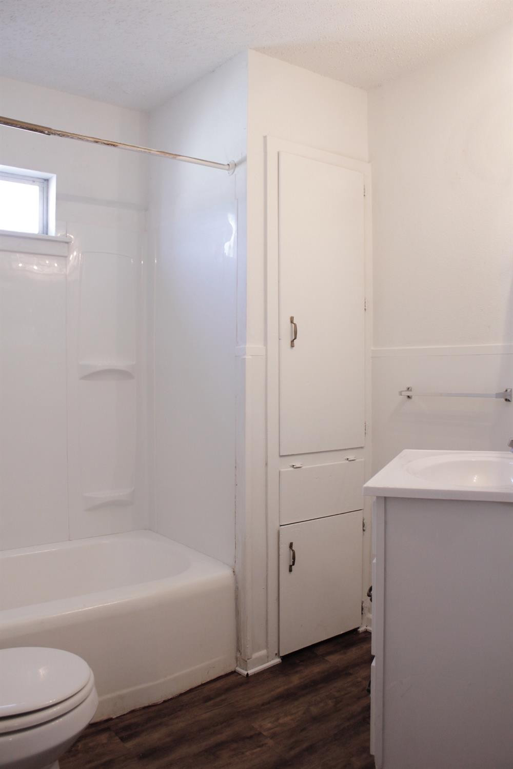 4424 36th Street, Unit A Lubbock, TX 79414 - Photo 6 of 6 a bathroom with a sink a toilet and shower