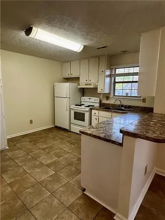 a bathroom with a sink a toilet a light fixture and a mirror
