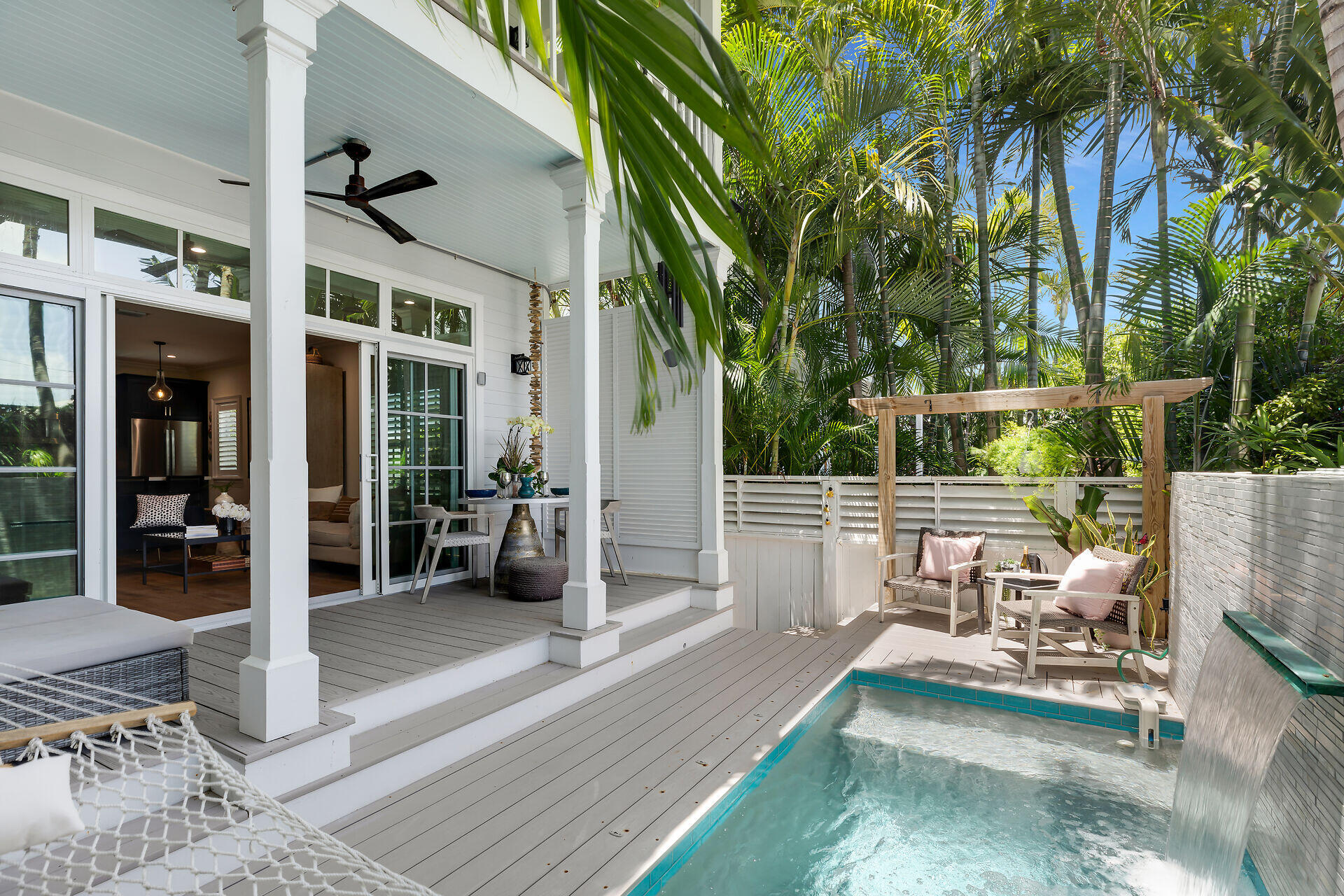205 Virginia Street Key West, FL 33040 - Photo 1 of 41 a view of a patio with couches table and chairs and potted plants