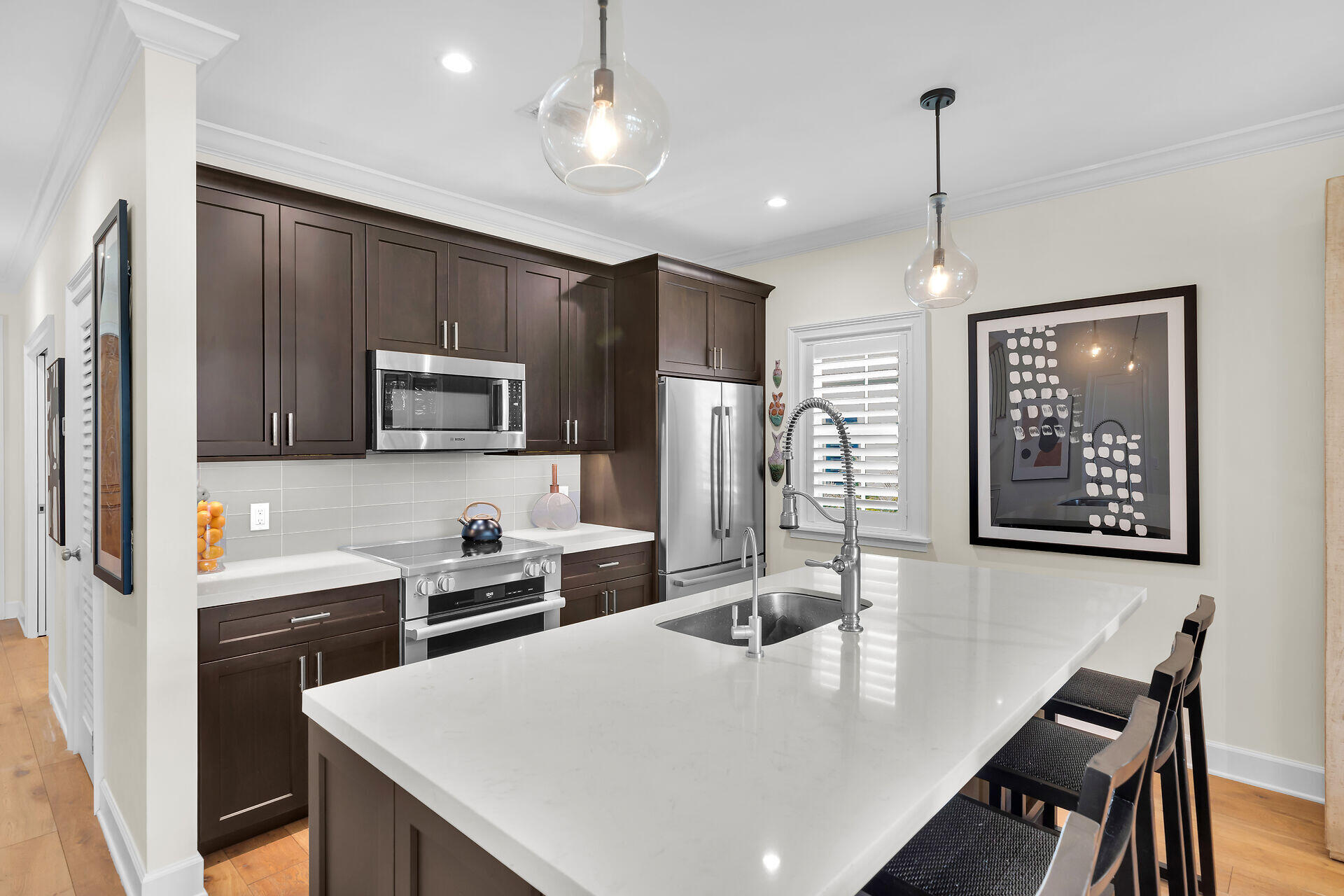 205 Virginia Street Key West, FL 33040 - Photo 19 of 41 a kitchen with stainless steel appliances a table chairs microwave and refrigerator