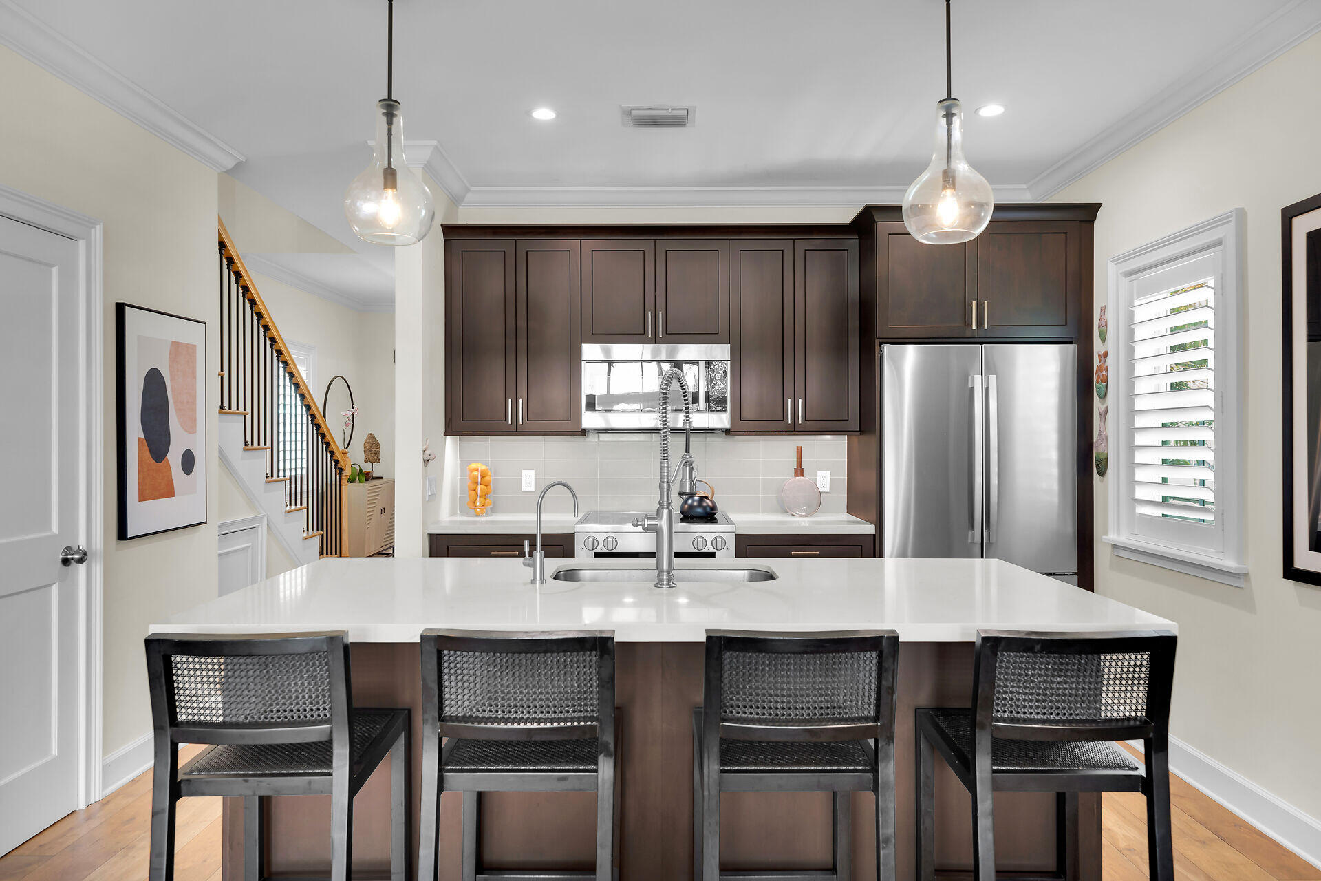 205 Virginia Street Key West, FL 33040 - Photo 20 of 41 a kitchen with granite countertop a table chairs stove refrigerator and microwave