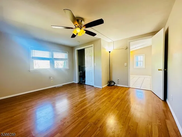 a view of empty room with wooden floor