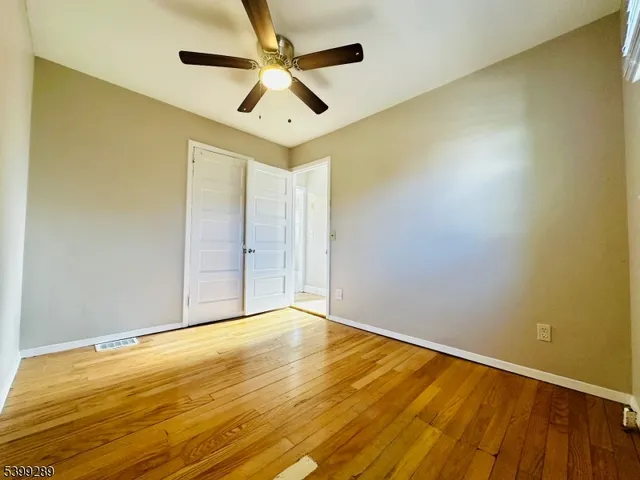 a view of a house with wooden fence