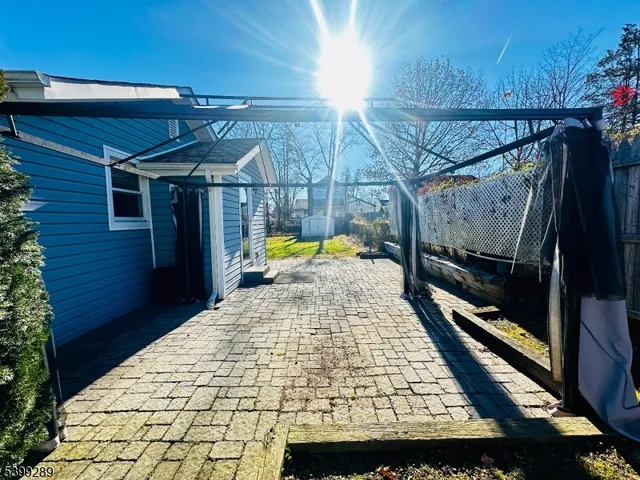 a view of a golf ground with large trees