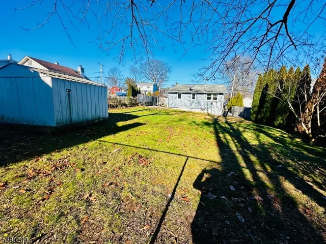 a view of a house with a backyard