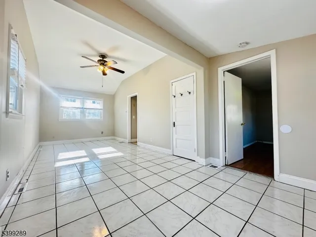 a view of entryway with window and a chandelier fan