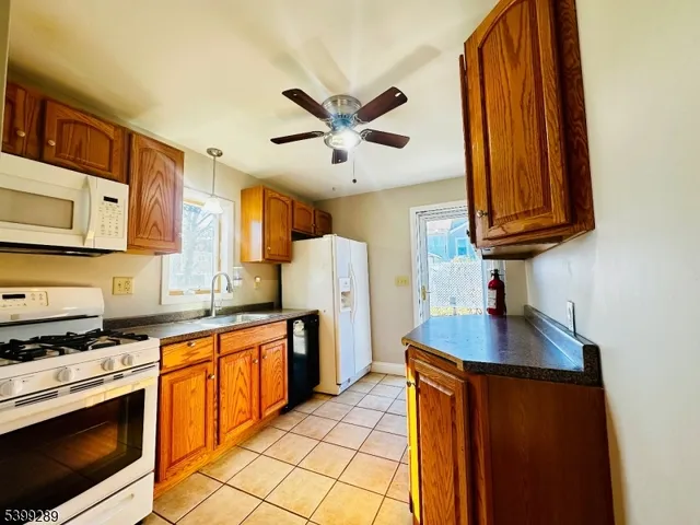 a kitchen with a sink a counter top space cabinets and stainless steel appliances