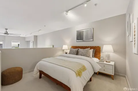 a bedroom with a bed and a chair