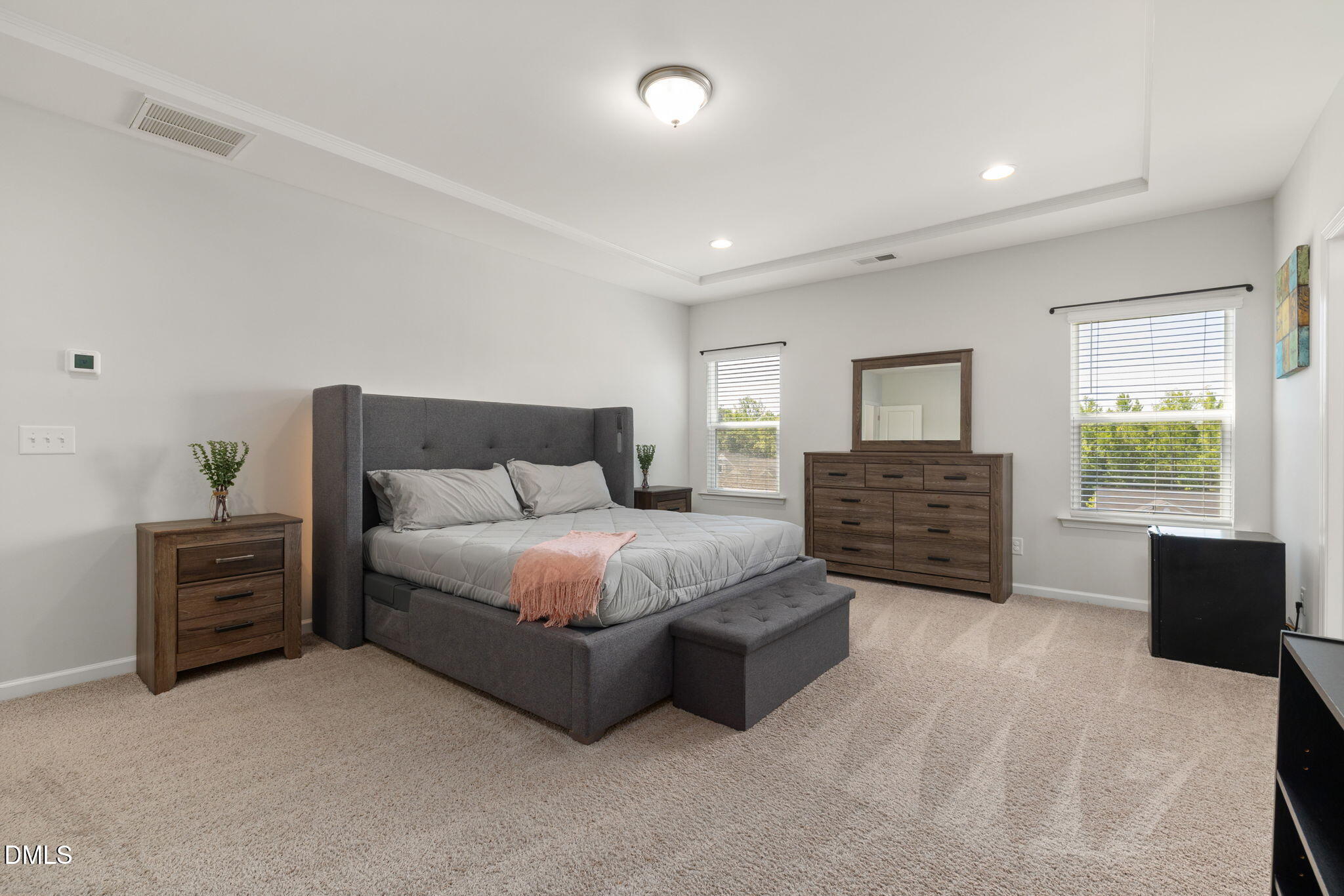 3422 Longleaf Estates Drive Raleigh, NC 27616 - Photo 32 of 71 a spacious bedroom with a bed and dresser with mirror