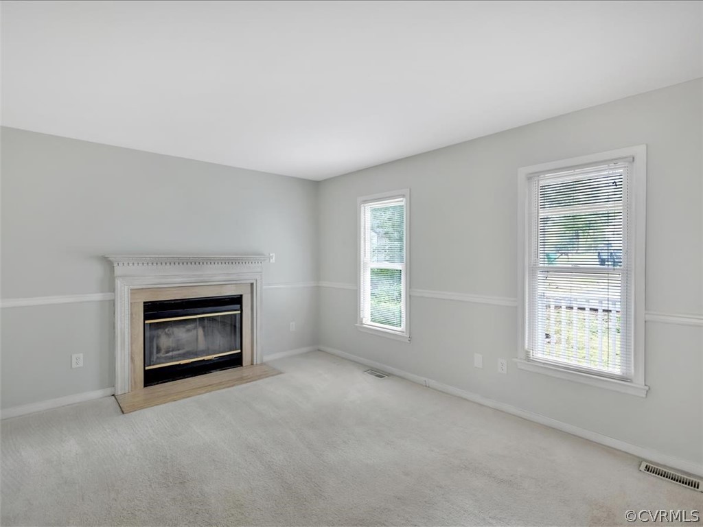 12402 South Ridge Circle Midlothian, VA 23112 - Photo 3 of 16 an empty room with a fireplace and windows