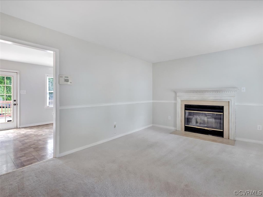 12402 South Ridge Circle Midlothian, VA 23112 - Photo 4 of 16 an empty room with a fireplace and cabinet