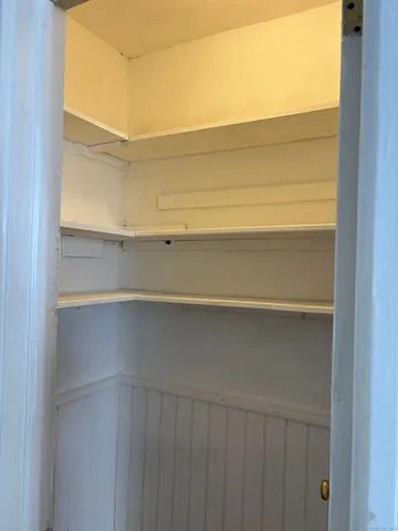 a bathroom with a toilet sink vanity and mirror