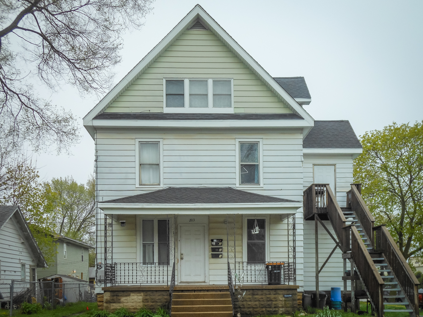 203 5th Avenue Rochelle, IL 61068 - Photo 1 of 25 a front view of a house with garden