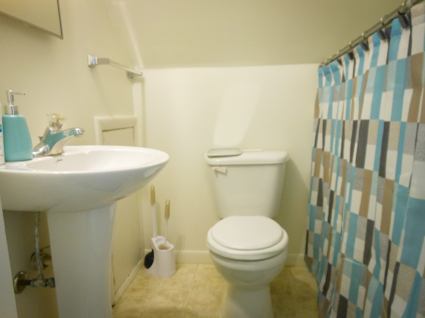 203 5th Avenue Rochelle, IL 61068 - Photo 7 of 25 a bathroom with a sink a toilet and shower curtain