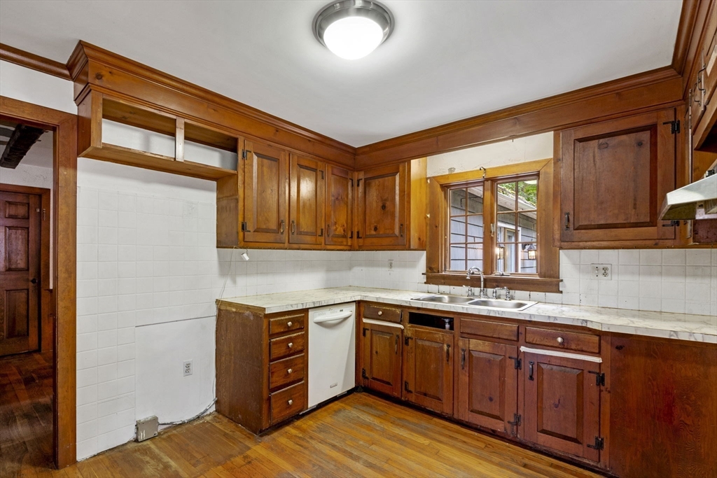 20 Main Street Boxford, MA 01921 - Photo 16 of 40 a kitchen with stainless steel appliances granite countertop a sink stove and cabinets