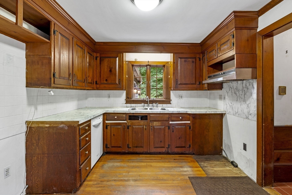 20 Main Street Boxford, MA 01921 - Photo 17 of 40 a kitchen with stainless steel appliances granite countertop a sink stove and cabinets