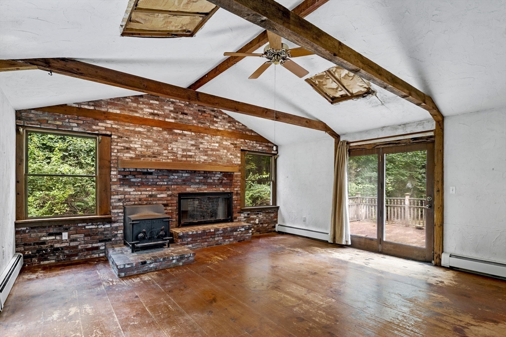 20 Main Street Boxford, MA 01921 - Photo 24 of 40 a view of an empty room with wooden floor and a fireplace