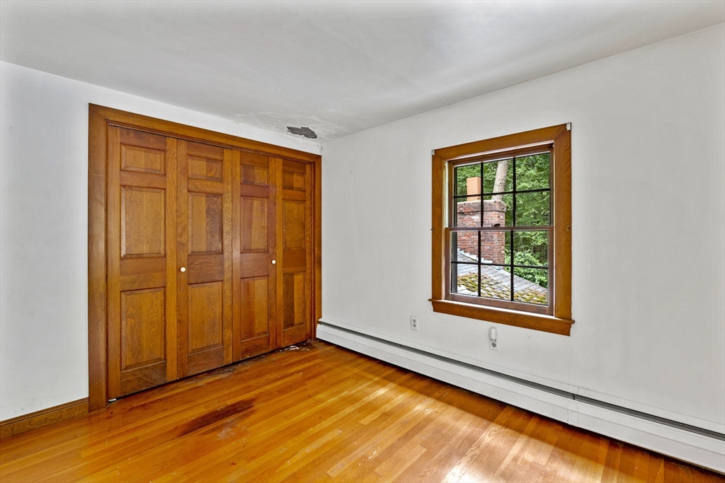 20 Main Street Boxford, MA 01921 - Photo 31 of 40 an empty room with wooden floor closet and windows