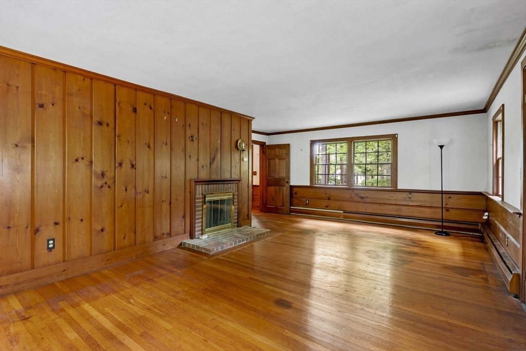 20 Main Street Boxford, MA 01921 - Photo 9 of 40 a view of empty room with wooden floor and fireplace