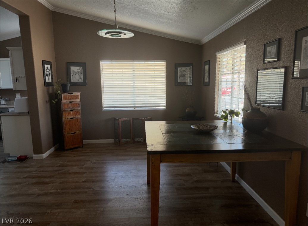 1270 Casey Road Pahrump, NV 89048 - Photo 2 of 6 Elegant crown molding graces the dining area, featuring attractive wood flooring and ample natural light.
