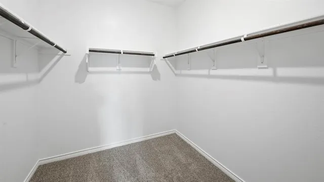 an empty room with fan and windows