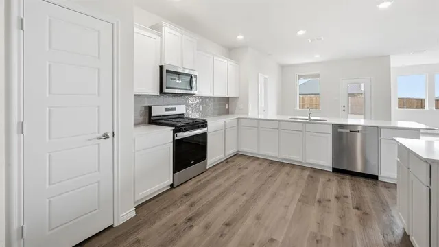 a kitchen with a sink and cabinets