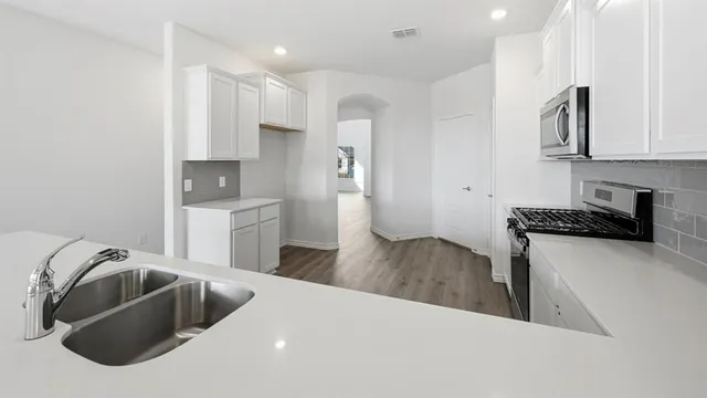 a view of a kitchen with wooden floor