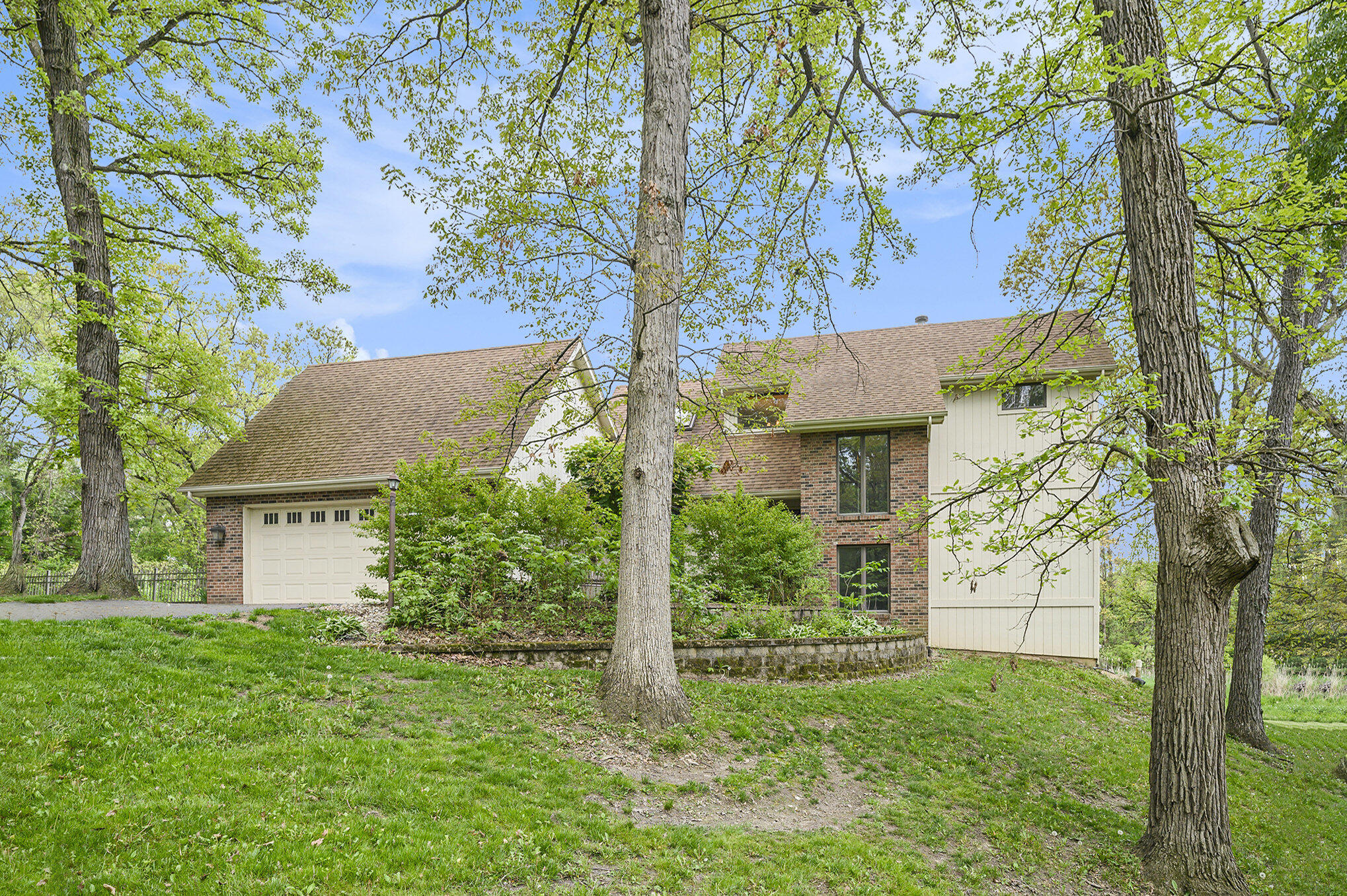 a view of a house with a tree and a yard