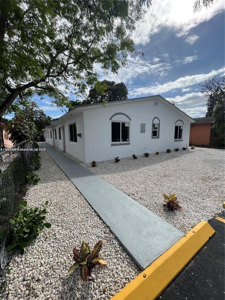 840 Southwest 6th Court, Unit C Pompano Beach, FL 33060 - Photo 2 of 6 a house view with a backyard space