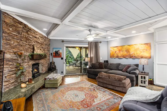 a living room with furniture a flat screen tv and a fireplace