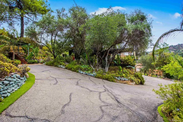 a view of a swimming pool with an outdoor seating and a garden