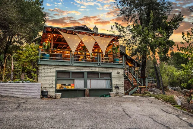 an aerial view of a houses with a yard
